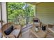 Charming screened-in porch with woven furniture and a tranquil view of the lush greenery at 35 Delray Dr. # 3A, Murrells Inlet, SC 29576