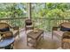 Relaxing screened-in porch with comfortable seating and a peaceful view of the surrounding trees at 35 Delray Dr. # 3A, Murrells Inlet, SC 29576