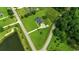 Overhead view showcasing a house with a large yard near a serene pond and woods at 3511 Sumpter Rd., Loris, SC 29569