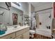 Bright bathroom features a combination tub and shower, framed mirror, and storage shelves at 3511 Sumpter Rd., Loris, SC 29569