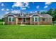 Charming brick home featuring a well-maintained lawn and inviting front porch at 3511 Sumpter Rd., Loris, SC 29569