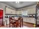 Traditional style kitchen featuring wooden table with white cabinets and dark countertops at 3511 Sumpter Rd., Loris, SC 29569