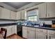 Traditional style kitchen featuring white cabinets, dark countertops, and a black dishwasher at 3511 Sumpter Rd., Loris, SC 29569