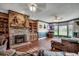 Cozy living room featuring a brick fireplace, built-in shelving, and hardwood floors at 3511 Sumpter Rd., Loris, SC 29569
