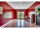 Large room with red walls and french doors leading to the outside at 3511 Sumpter Rd., Loris, SC 29569