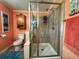 This bathroom features a glass shower enclosure and storage cabinet with a soft peach color scheme at 356 Lakeside Crossing Dr., Conway, SC 29526