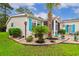 A charming home is showcased by meticulous landscaping with decorative stone and lush green lawn at 356 Lakeside Crossing Dr., Conway, SC 29526