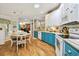 A bright kitchen and dining area displaying wood floors and two-tone cabinetry at 356 Lakeside Crossing Dr., Conway, SC 29526