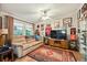 Warm living room with a plush couch, large TV, and lots of memorabilia displayed on the walls at 356 Lakeside Crossing Dr., Conway, SC 29526