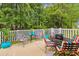 An outdoor patio with artificial grass, colorful chairs, tables, and potted plants and trees at 356 Lakeside Crossing Dr., Conway, SC 29526