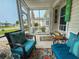Relaxing screened-in porch with comfortable wicker seating and a view of the landscaped yard at 356 Lakeside Crossing Dr., Conway, SC 29526