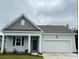 Charming single-story home featuring a covered porch, attached garage, and neatly landscaped front yard at 3587 Ashridge Way, Conway, SC 29526