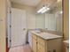 Bathroom featuring white cabinets, tile floor, and a large mirror at 3904 Williamson Circle, Myrtle Beach, SC 29579
