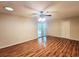 Large bedroom with hardwood floors, a ceiling fan, and a bathroom entrance at 3904 Williamson Circle, Myrtle Beach, SC 29579