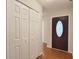 A welcoming entryway features hardwood flooring, a dark wood front door with glass accents, and a double closet at 3904 Williamson Circle, Myrtle Beach, SC 29579