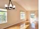 Bright and airy living room featuring large windows, hardwood floors, and modern chandelier at 3904 Williamson Circle, Myrtle Beach, SC 29579