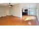 Open-concept living room with hardwood floors, high ceilings, ceiling fan, and view of the kitchen at 3904 Williamson Circle, Myrtle Beach, SC 29579