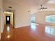 This spacious living room features gleaming hardwood floors, neutral paint, and plenty of natural light from large windows at 3904 Williamson Circle, Myrtle Beach, SC 29579