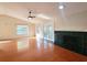 Open-concept living room with hardwood floors, a fireplace, high ceilings, and a ceiling fan at 3904 Williamson Circle, Myrtle Beach, SC 29579