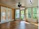 Bright sunroom with many windows, French doors, wood floors, and a ceiling fan at 3904 Williamson Circle, Myrtle Beach, SC 29579