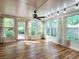 Bright sunroom with hardwood floors, ceiling fan, many windows with views, and natural light at 3904 Williamson Circle, Myrtle Beach, SC 29579