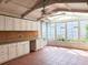 Bright sunroom with white cabinets, tile flooring, and many windows at 3904 Williamson Circle, Myrtle Beach, SC 29579