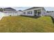 Backyard of the home featuring a well-manicured lawn, white vinyl fence, and a covered patio at 4206 Falls Oaks St., Myrtle Beach, SC 29579