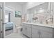 Bathroom with double sinks, gray cabinets, white countertop and decor at 4206 Falls Oaks St., Myrtle Beach, SC 29579