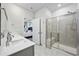 Bright bathroom with double sinks, quartz countertops, glass enclosed tiled shower, and access to the main bedroom at 4206 Falls Oaks St., Myrtle Beach, SC 29579