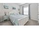 Charming bedroom with a queen bed, soft blue accents, beach artwork and bedside tables at 4206 Falls Oaks St., Myrtle Beach, SC 29579