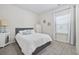 Inviting bedroom featuring a queen bed, neutral tones, and a bright window at 4206 Falls Oaks St., Myrtle Beach, SC 29579