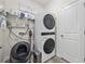 Efficient laundry room with stacked washer and dryer, storage shelves, and good lighting at 4206 Falls Oaks St., Myrtle Beach, SC 29579