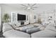 Open-concept living room with a gray sectional, tv, and view into the kitchen at 4206 Falls Oaks St., Myrtle Beach, SC 29579