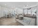 Bright living room open to a dining area, featuring a sectional sofa and large windows at 4206 Falls Oaks St., Myrtle Beach, SC 29579