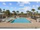 Community pool with a zero entry access point, palm trees, and plenty of lounge chairs at 4206 Falls Oaks St., Myrtle Beach, SC 29579