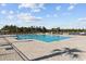 Open community pool with a large deck, seating, and a beautiful view of the lake at 4206 Falls Oaks St., Myrtle Beach, SC 29579