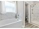 Modern bathroom showcasing a soaking tub with marble tile surround and glass enclosed shower at 432 Rose Fountain Dr., Myrtle Beach, SC 29579