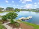 Scenic view of a lakefront with a dock, walking path, and beautiful landscaping in a residential community at 432 Rose Fountain Dr., Myrtle Beach, SC 29579