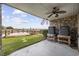 Inviting outdoor space featuring a ceiling fan, lush lawn, and scenic water view, perfect for entertaining at 465 Vereen Rd. # 10, Murrells Inlet, SC 29576