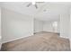 Large carpeted bedroom featuring neutral walls, a ceiling fan, and a doorway to the bathroom at 465 Vereen Rd. # 10, Murrells Inlet, SC 29576