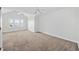 Spacious bedroom with neutral carpeting, a ceiling fan, and a window for natural light at 465 Vereen Rd. # 10, Murrells Inlet, SC 29576