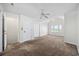 Bright, carpeted bedroom featuring a ceiling fan, ample closet space, and a window at 465 Vereen Rd. # 10, Murrells Inlet, SC 29576