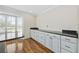 Kitchen features white cabinets, granite countertops and a bright breakfast nook with natural light at 465 Vereen Rd. # 10, Murrells Inlet, SC 29576