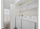 Laundry area with front-loading washer and dryer and shelving at 465 Vereen Rd. # 10, Murrells Inlet, SC 29576