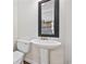 Classic powder room with pedestal sink, toilet, and a decorative mirror, accented by black and white tile at 465 Vereen Rd. # 10, Murrells Inlet, SC 29576