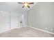 Bedroom with neutral carpet, ceiling fan, and access to bathroom and closets at 4767 Wild Iris Dr. # 203, Myrtle Beach, SC 29579