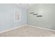Neutral bedroom with plantation shutters, shelving, and carpeting at 4767 Wild Iris Dr. # 203, Myrtle Beach, SC 29579