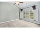 Light-filled bedroom with neutral carpet, vaulted ceiling, and a bright window at 4767 Wild Iris Dr. # 203, Myrtle Beach, SC 29579
