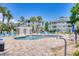 Community pool surrounded by palm trees and lounge chairs at 4767 Wild Iris Dr. # 203, Myrtle Beach, SC 29579