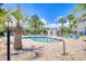 Community swimming pool with lounge chairs and shade, surrounded by lush palm trees and well-maintained landscaping at 4767 Wild Iris Dr. # 203, Myrtle Beach, SC 29579